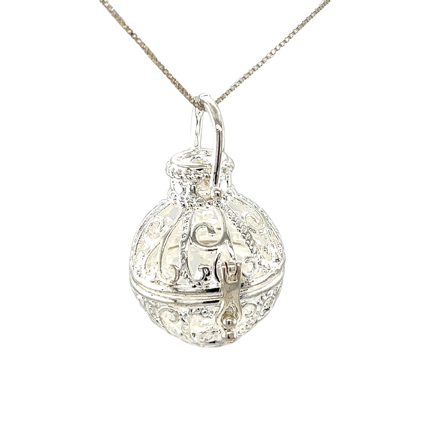 
                  
                    A Super Silver Filigree Cage Pendant on a chain adorned with an ornate Bali cage.
                  
                