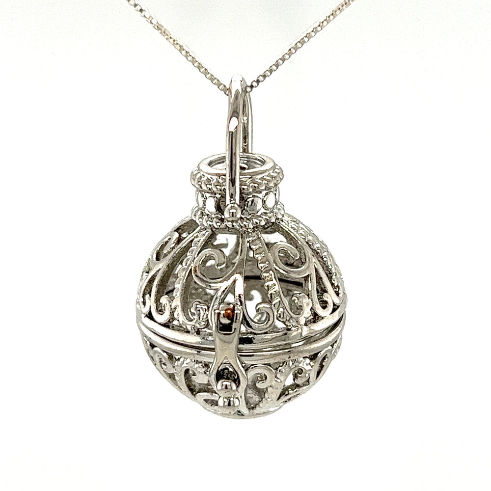 
                  
                    A Filigree Cage Pendant from Super Silver on a chain.
                  
                