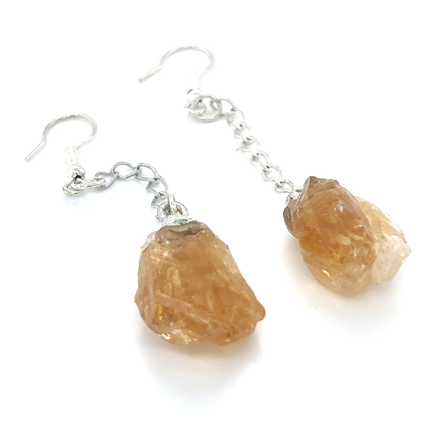 
                  
                    A pair of Super Silver long crystal earrings with orange crystals.
                  
                