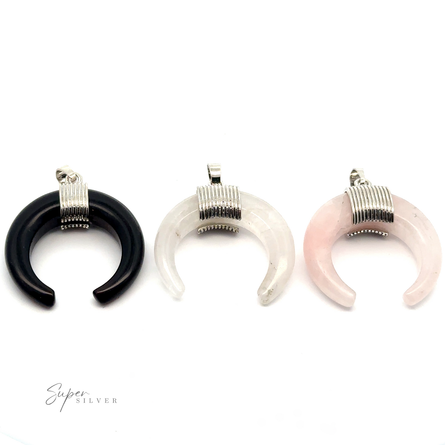 Three Naja Stone Pendants in black, white, and pink with silver wrapped tops evoke the classic elegance of Navajo crescent designs and are displayed against a white background.