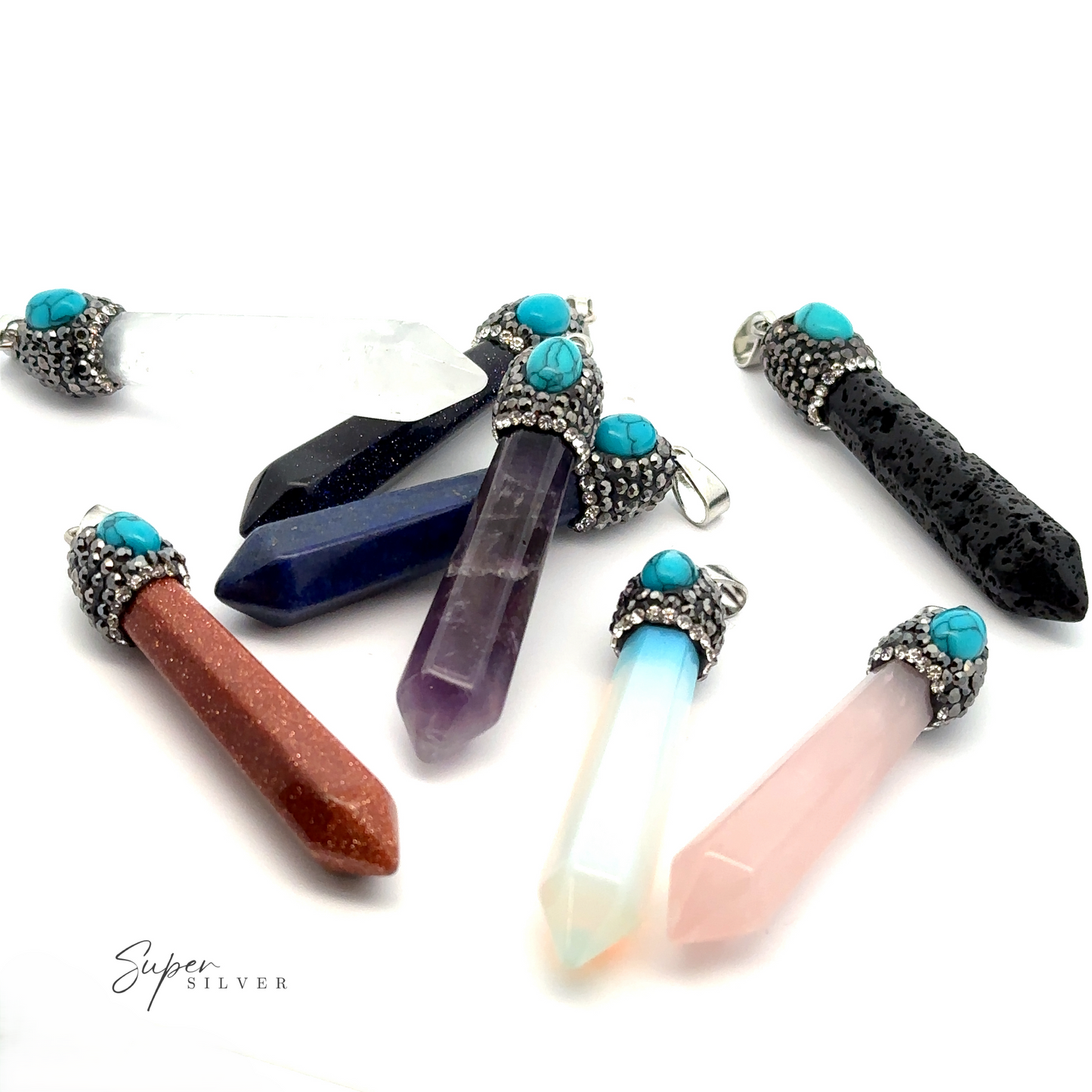The image displays various gemstone pendants with silver caps and turquoise accents, featuring stones like rose quartz, amethyst, black tourmaline, and others. Among them, a Stone Obelisk Pendant with striking clarity stands out, all beautifully arranged on a white background.
