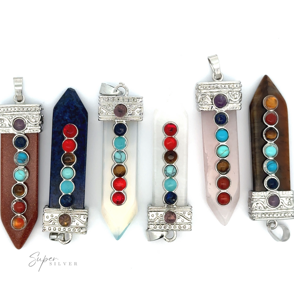 
                  
                    Image of six Obelisk Crystal Pendants with Small Chakra Stones, each with a series of chakra stones along their length. The pendants are adorned with silver detailing and feature elegant silver-plated designs in various hues and shapes.
                  
                