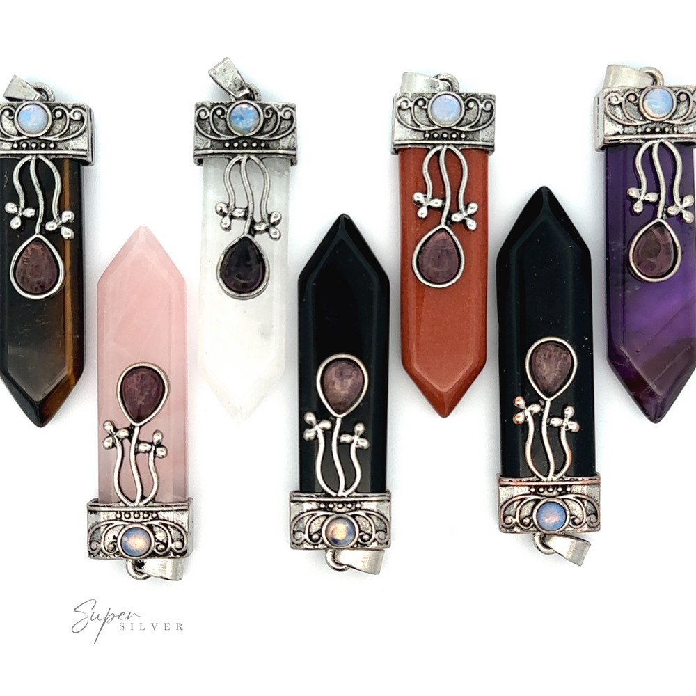 A collection of seven pointed gemstone pendants with ornate metallic caps featuring various stones and designs. The gems include black, brown, white, pink, red, and purple hues. One standout piece is the Obelisk Crystal Stone Pendant with a beautiful Amethyst that captures the essence of bohemian elegance.