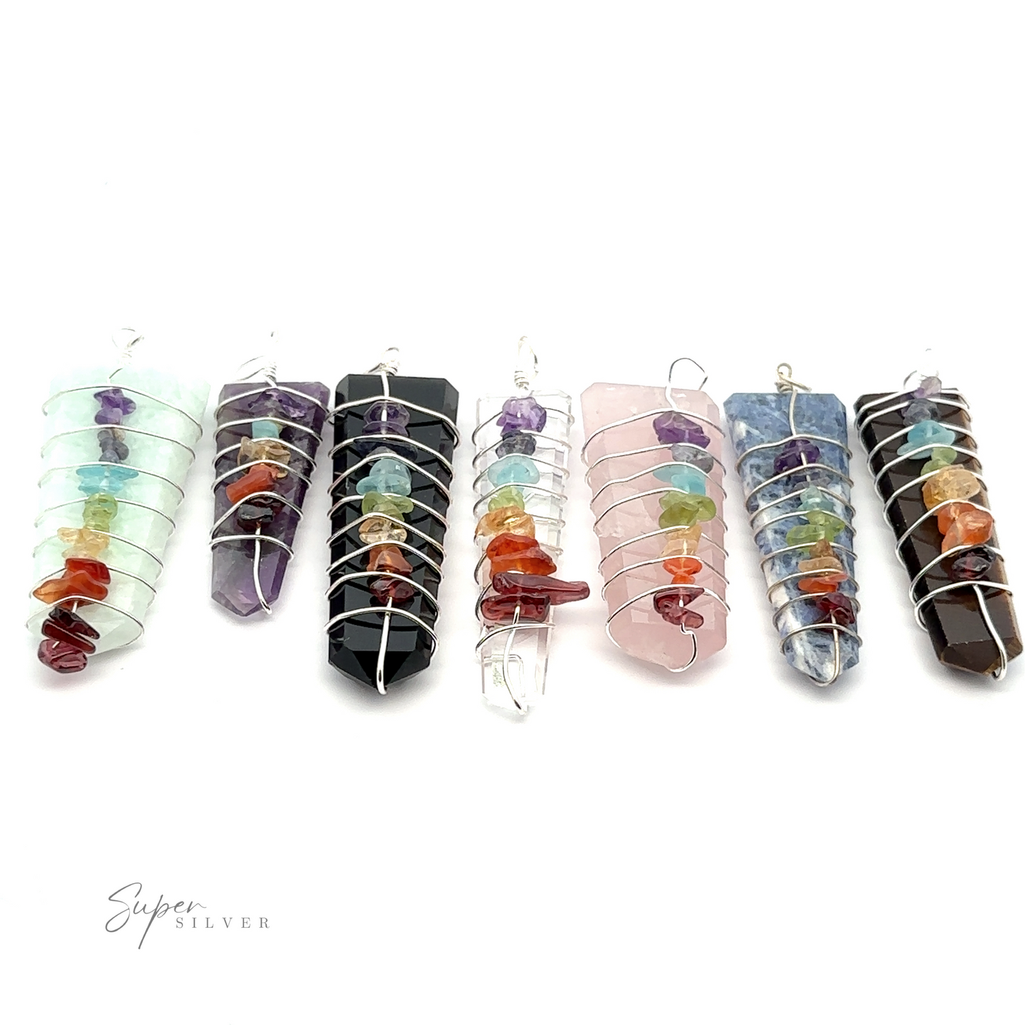 Seven Stone Slab Wire-Wrapped Chakra Pendants, each containing multicolored smaller chakra stones inside, are aligned in a row against a white background.