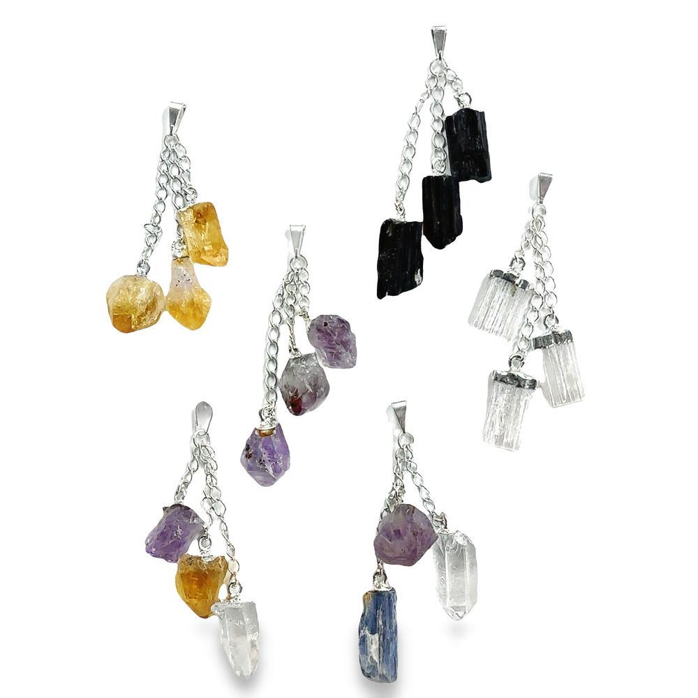 Triple Crystal Pendants with vibrant crystals in various hues adorning a collection of necklaces.