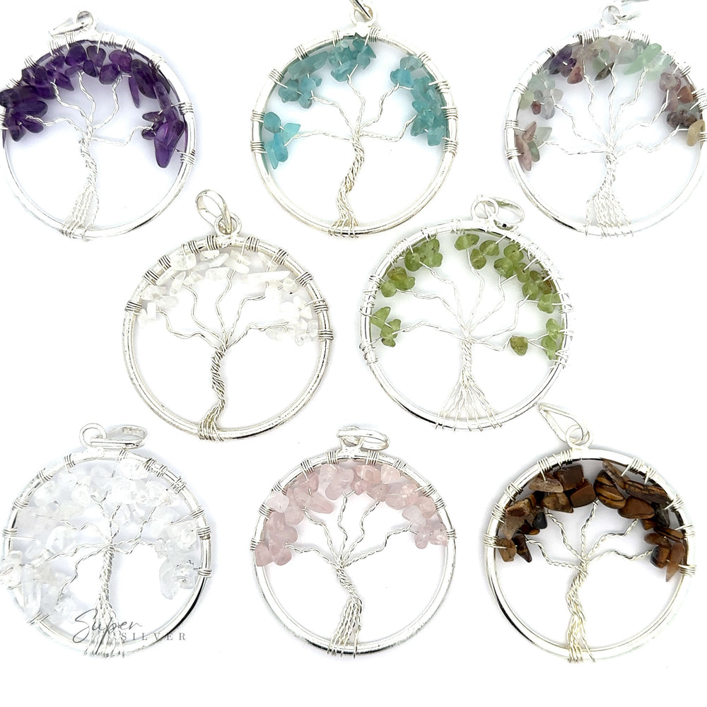Seven circular Wire Wrapped Tree of Life Pendants with Stones are displayed, each exquisitely wire-wrapped and adorned with different colored gemstones including purple, blue, green, clear, pink, and brown.