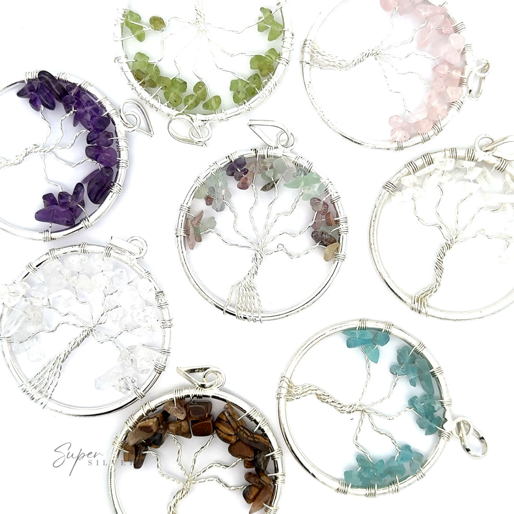Discover our collection of Wire Wrapped Tree of Life Pendant with Stones, intricately wire-wrapped with vibrant gemstones in hues of purple, green, pink, clear, white, and brown, artfully arranged on a pristine white background.