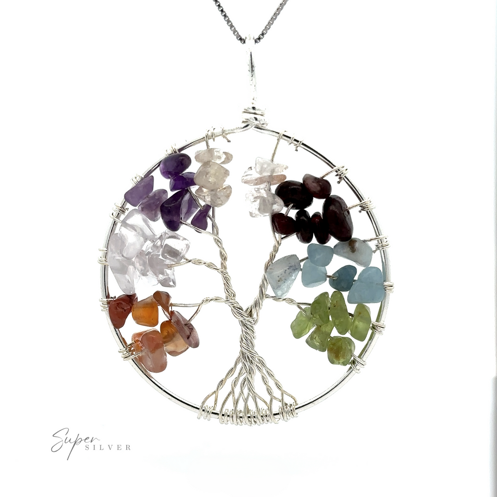
                  
                    A Wire Wrapped Tree of Life Pendant featuring branches adorned with multicolored gemstone chips, attached to a silver chain. This exquisite Wire Wrapped Tree of Life Pendant artfully blends mixed metals for a unique touch.
                  
                