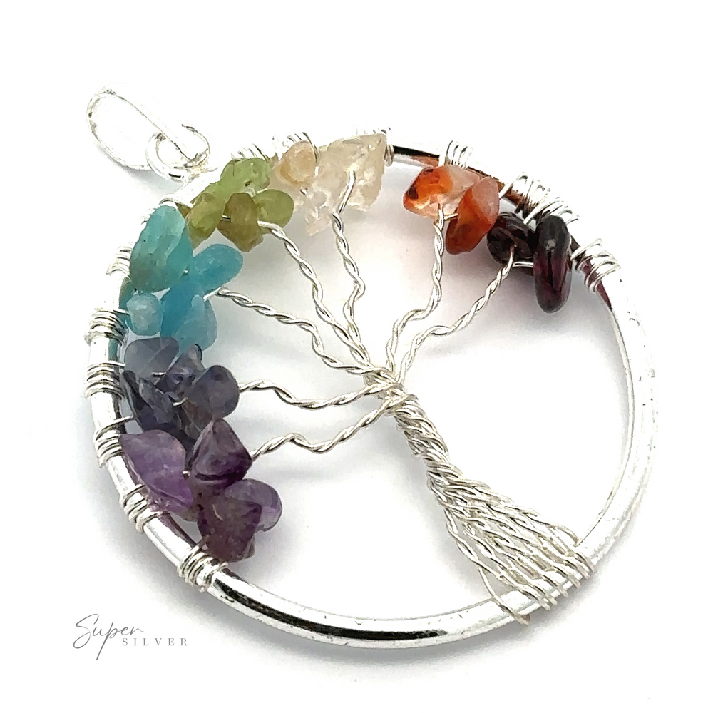 
                  
                    A Wire-Wrapped Chakra Tree of Life Pendant features a wire-wrapped design with branches adorned with multicolored chakra stones.
                  
                