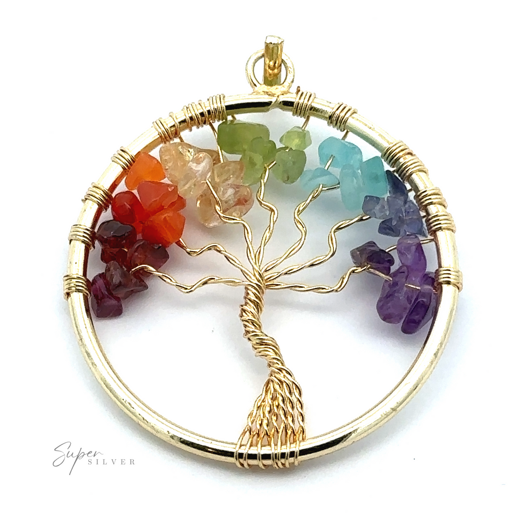 
                  
                    A circular Wire-Wrapped Chakra Tree of Life Pendant showcases a wire-wrapped tree with branches adorned with multicolored chakra stones, arranged in a spectrum from red to violet. The pendant has a gold finish.
                  
                