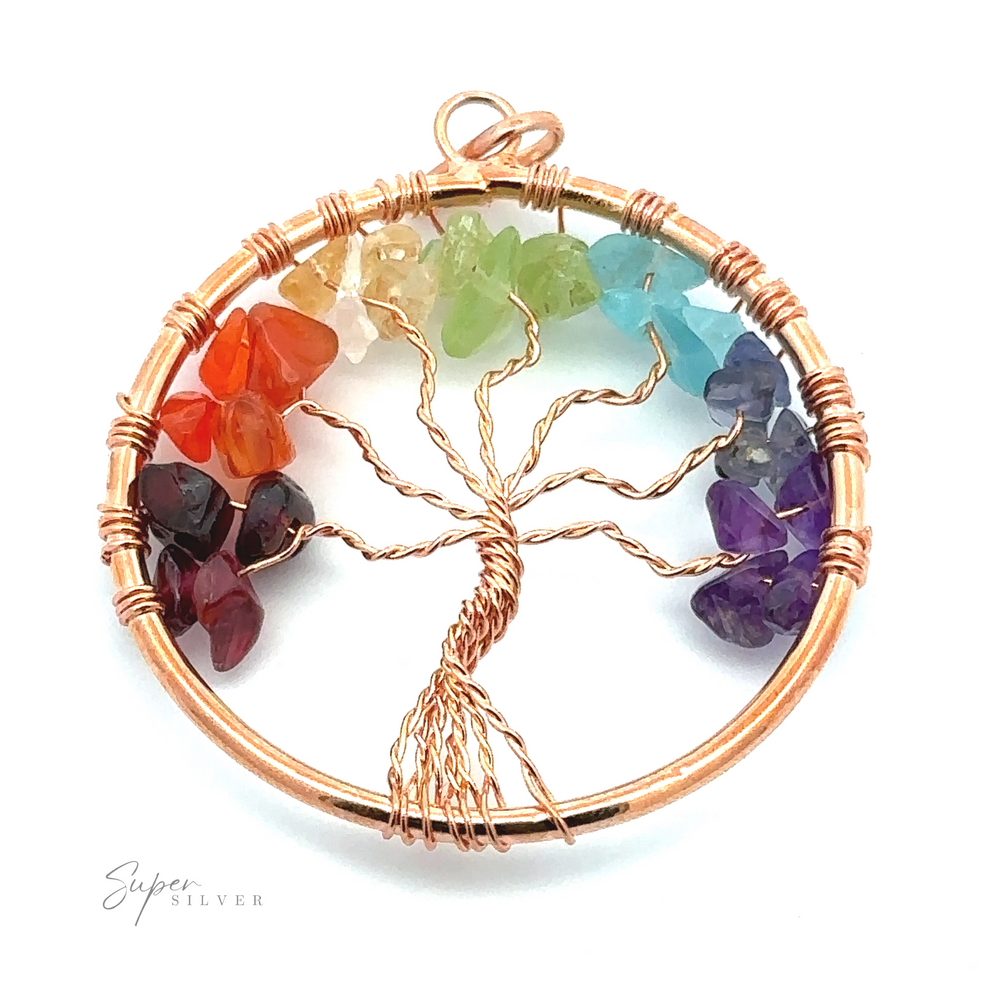 
                  
                    A Wire-Wrapped Chakra Tree of Life Pendant depicting a tree within a circular frame, adorned with multicolored chakra stones representing the seven chakras.
                  
                