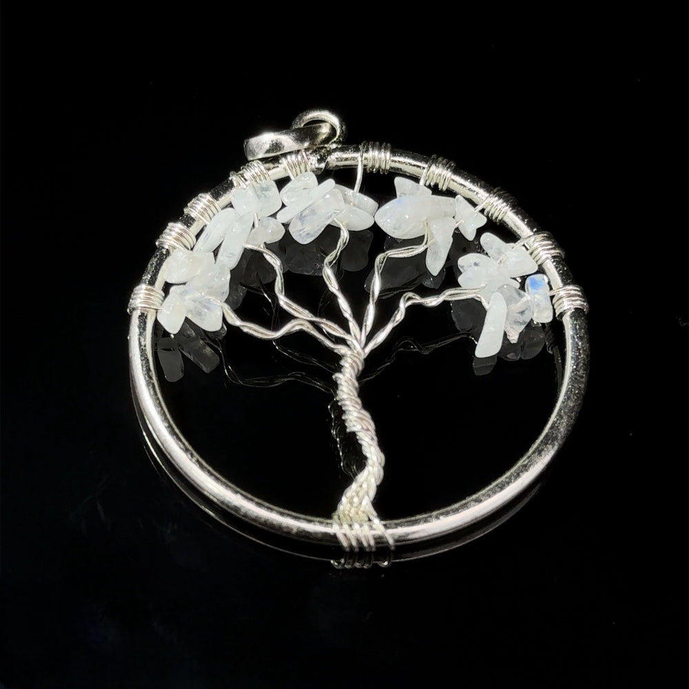 
                  
                    A Wire Wrapped Tree of Life Pendant with Stones, set against a black background.
                  
                
