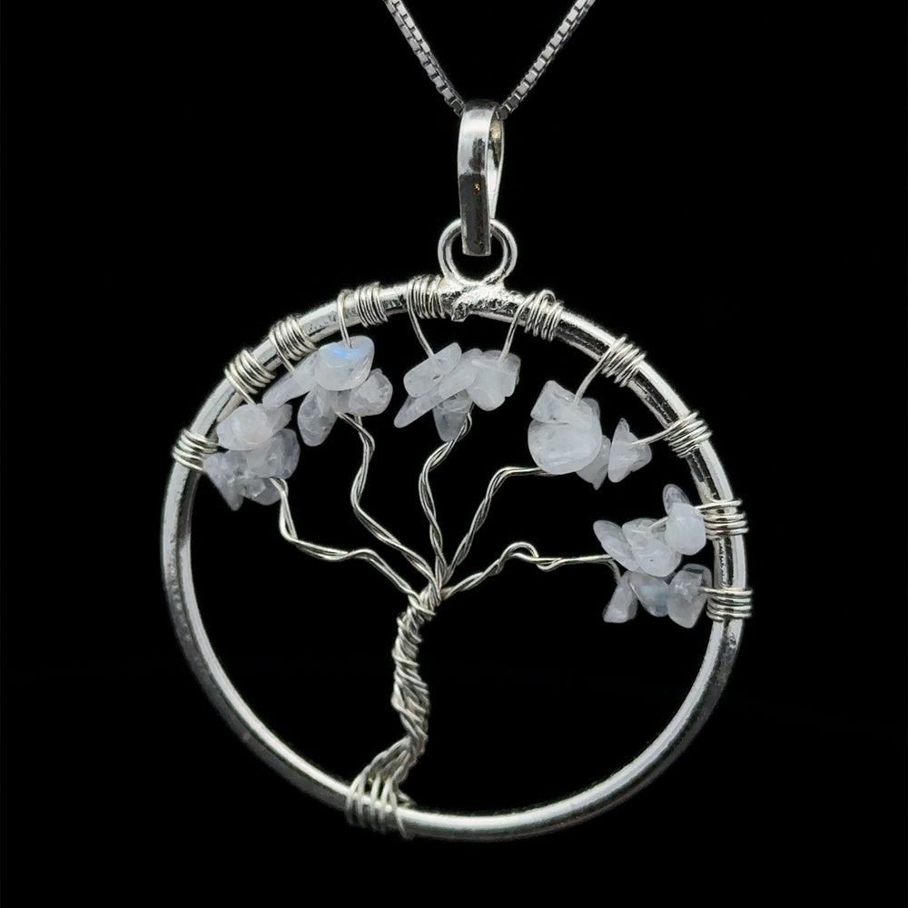 
                  
                    A stunning Wire Wrapped Tree of Life Pendant with Stones, featuring white gemstone leaves, suspended from a silver chain, and intricately wire wrapped for a unique touch.
                  
                