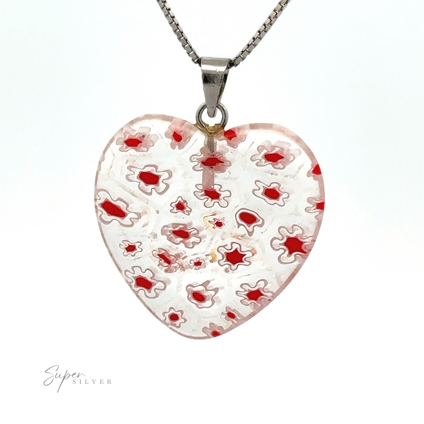 
                  
                    A Heart Pendant with Flower Pattern showcases a clear and red intricate pattern in translucent resin. The hallmark "Super Silver" is visible in the bottom left corner, adding a touch of authenticity to this charming piece.
                  
                