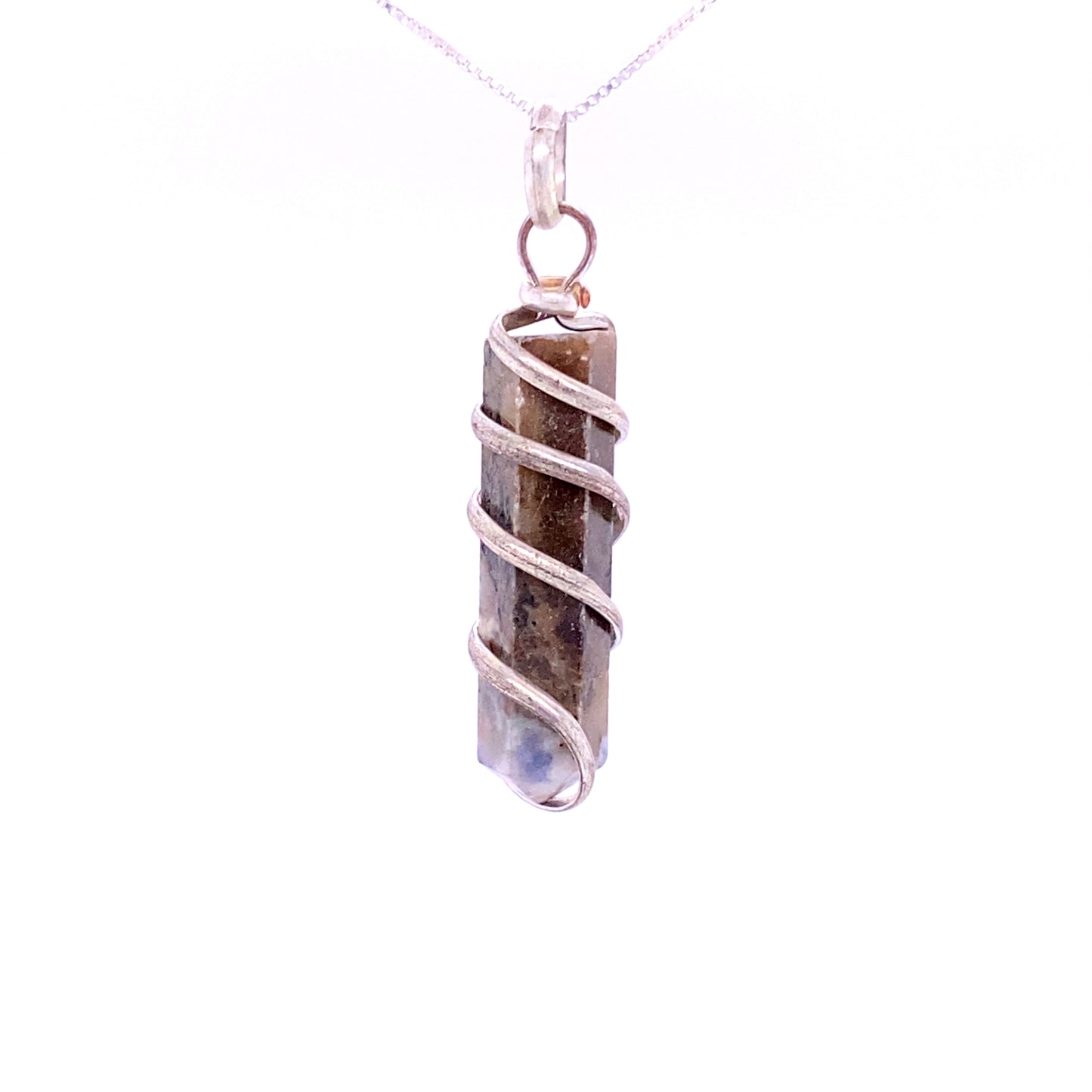 
                  
                    A **Wire Wrapped Stone Pendant** featuring a genuine cylindrical gemstone encased in silver wire, suspended from a delicate chain.
                  
                