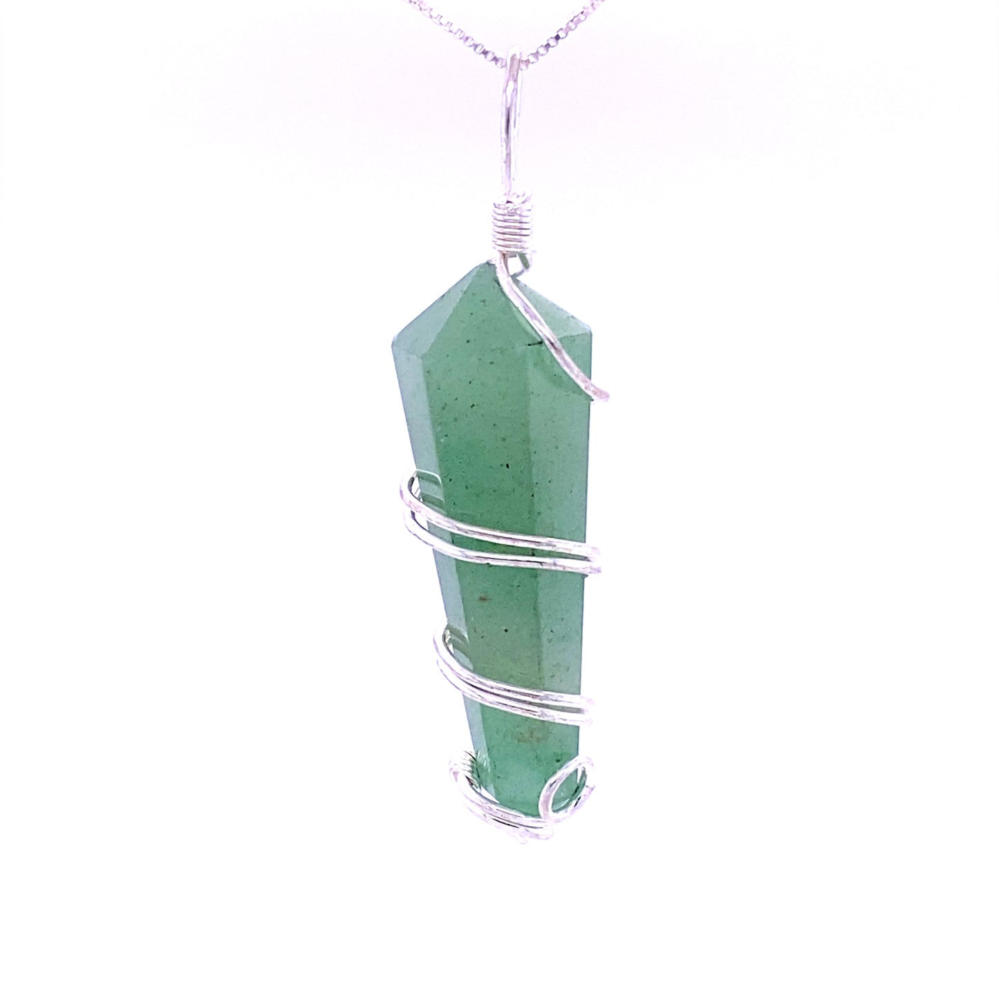 
                  
                    A genuine Wire Wrapped Stone Pendant, featuring a green crystal wrapped in silver wire, hangs from a silver chain against a white background.
                  
                