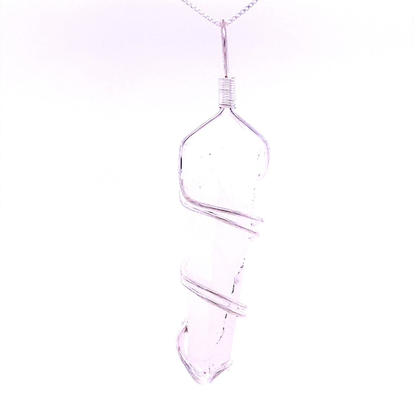 
                  
                    Close-up of the Wire Wrapped Stone Pendant, showcasing a clear, pointed crystal intricately wrapped in silver wire and suspended from a delicate chain.
                  
                