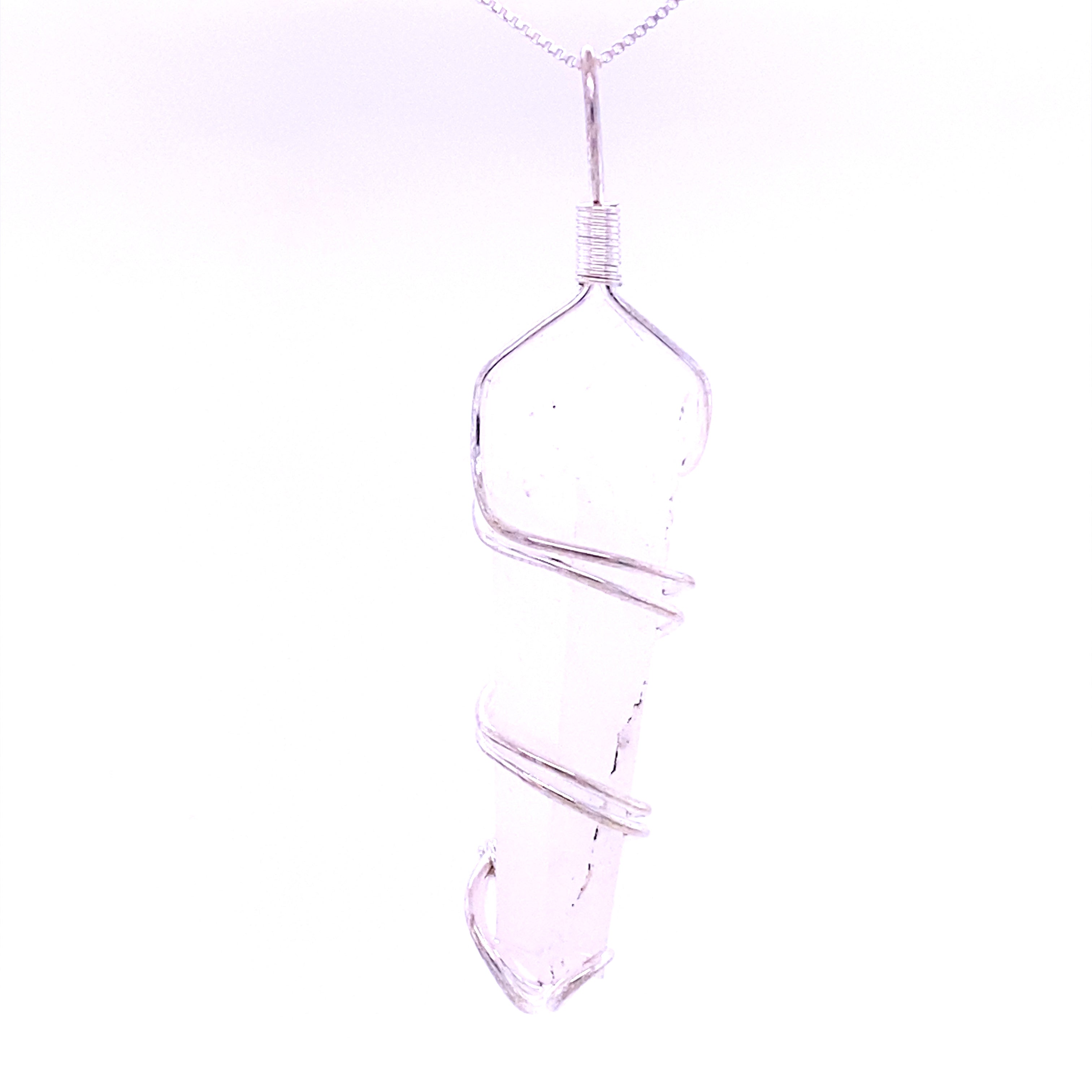 Close-up of the Wire Wrapped Stone Pendant, showcasing a clear, pointed crystal intricately wrapped in silver wire and suspended from a delicate chain.