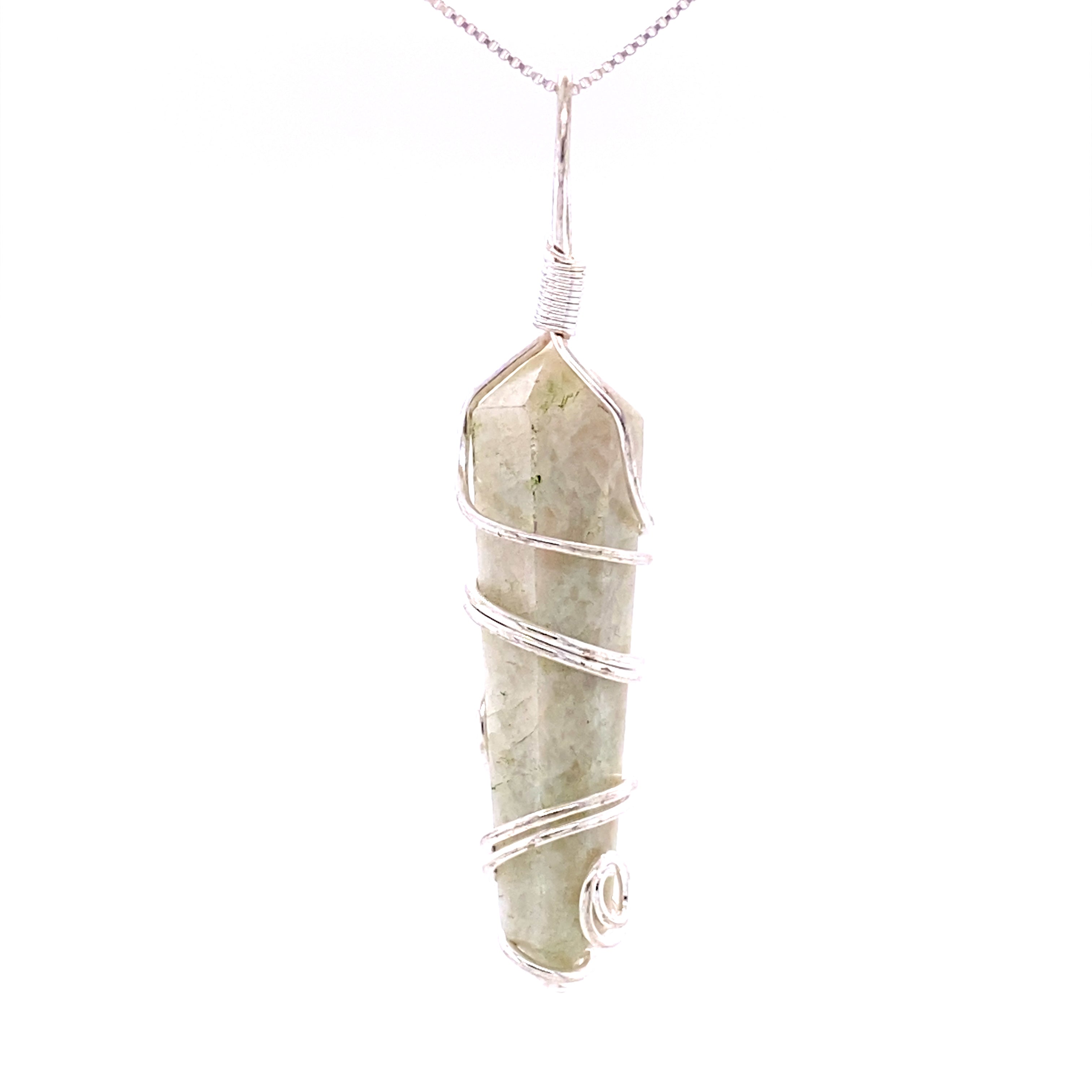 A silver chain displays an elongated, light green crystal pendant intricately wrapped in silver wire against a white background. This genuine Wire Wrapped Stone Pendant showcases the beauty of mixed metals jewelry with its expertly crafted gemstone setting.