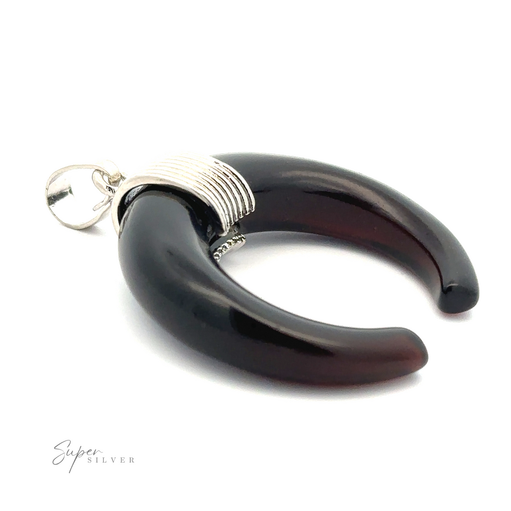 
                  
                    A black Naja Stone Pendant with a silver loop and wrapped silver wire detailing at the top. The crescent-shaped piece, inspired by Navajo design, is set against a white background with the "Super Silver" logo in the corner.
                  
                