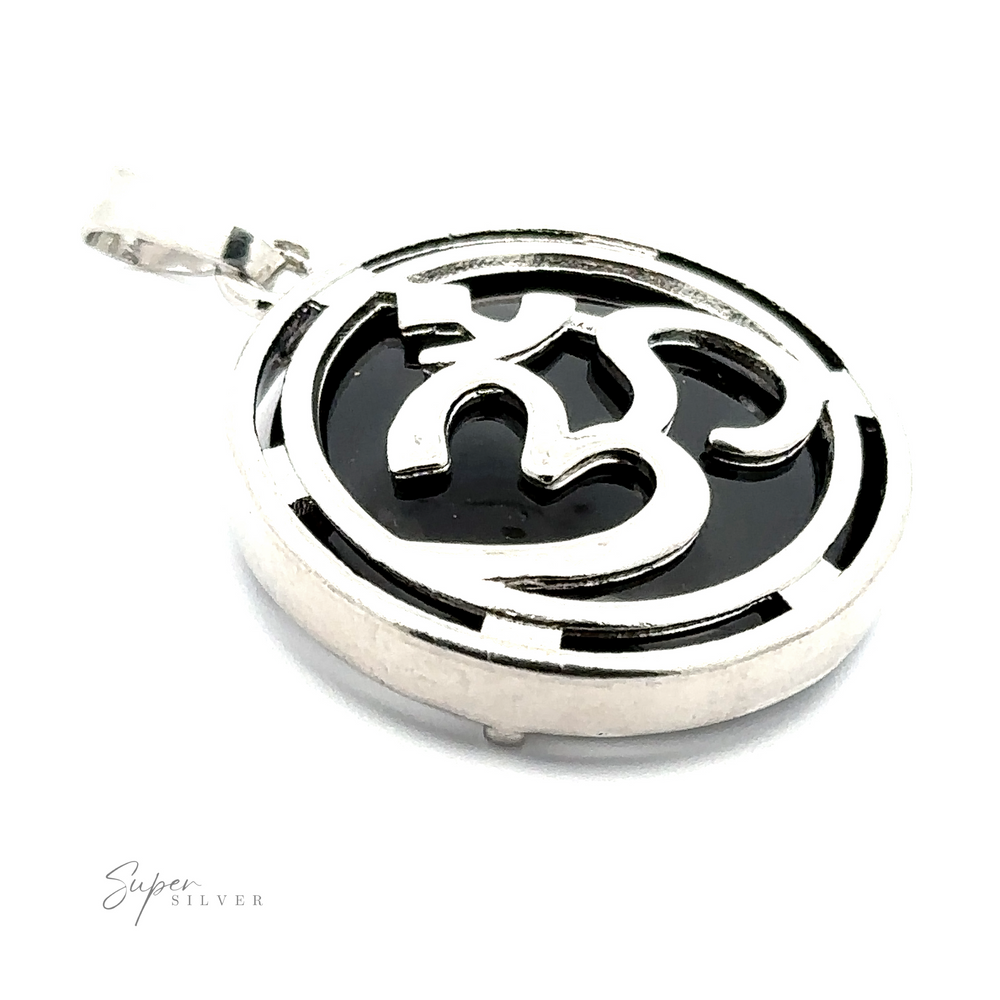 
                  
                    A silver-plated Om Pendant with a black background, featuring an intricate, stylized design.
                  
                