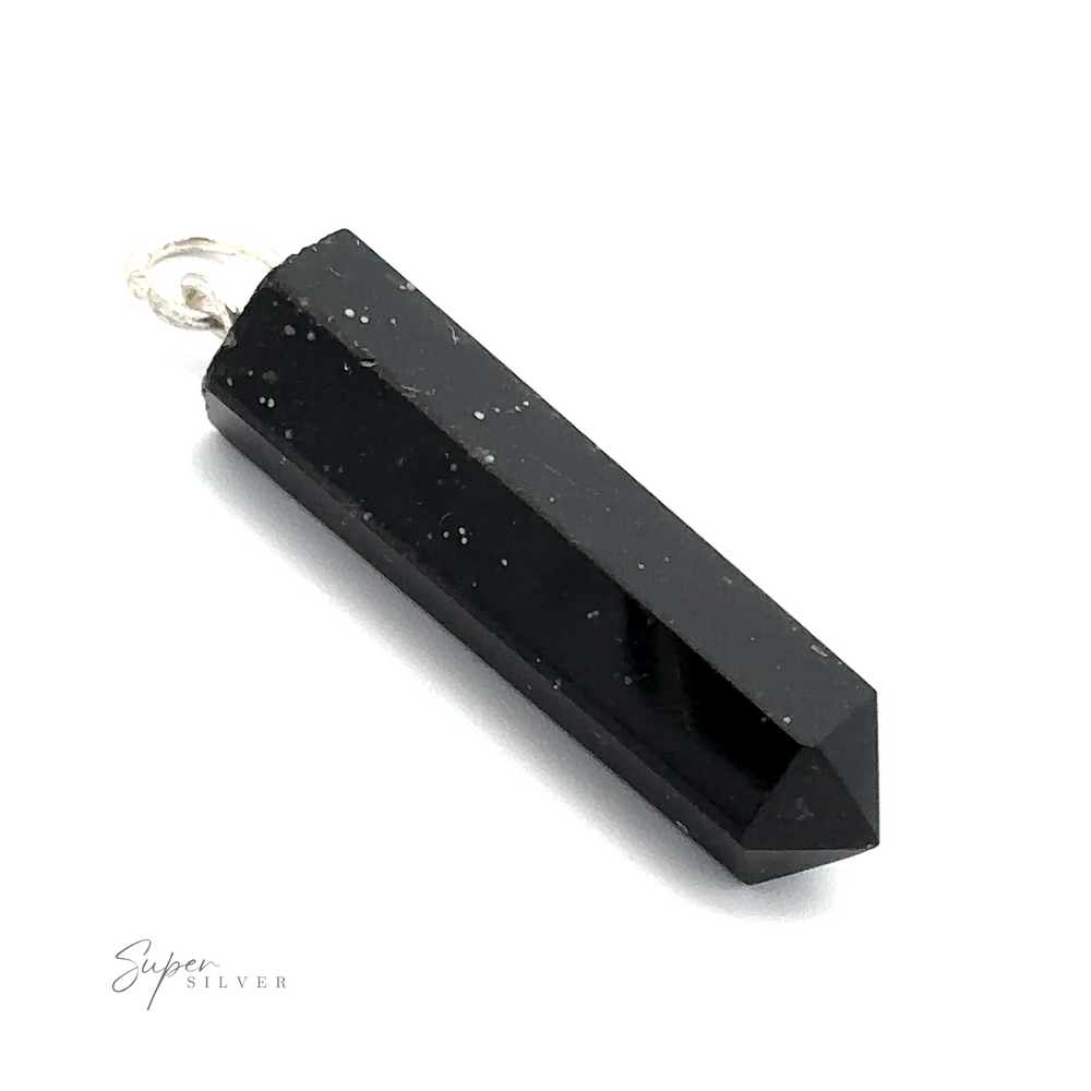 
                  
                    A black, hexagonal stone pendant with a pointed end and a metal loop at the top for attachment. The Raw Stone Obelisk Pendant is labeled "Super Silver" in the lower left corner.
                  
                