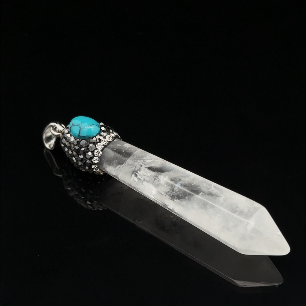 
                  
                    An Stone Obelisk Pendant featuring a clear quartz with a turquoise stone and hematite beads against a black background.
                  
                