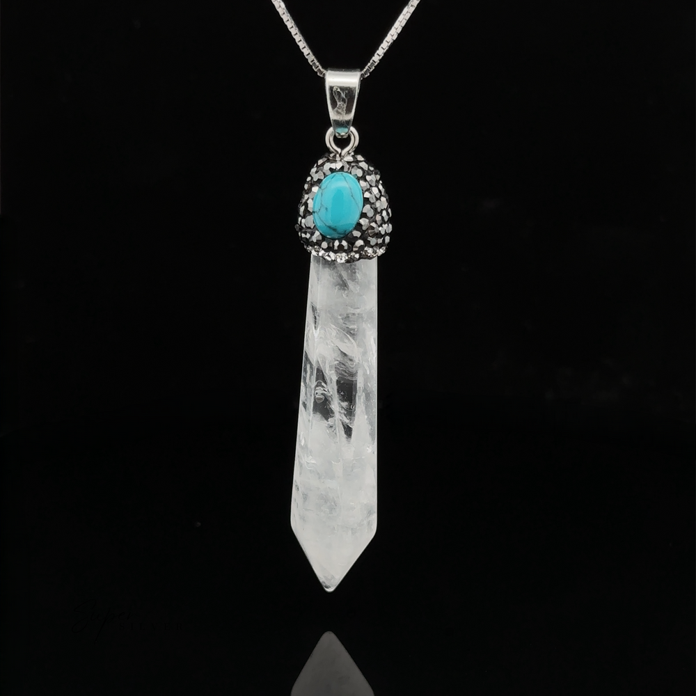 
                  
                    A pendant necklace featuring a clear quartz Stone Obelisk Pendant attached to a silver chain. The crystal is topped with a turquoise stone encased in a decorative silver setting. Hematite beads adorn the chain, adding an extra touch of elegance.
                  
                