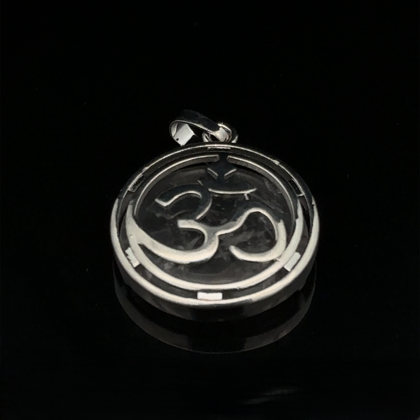 
                  
                    A round mixed metals silver plated Om Pendant featuring a delicate touch of opalite, displayed on a black background.
                  
                