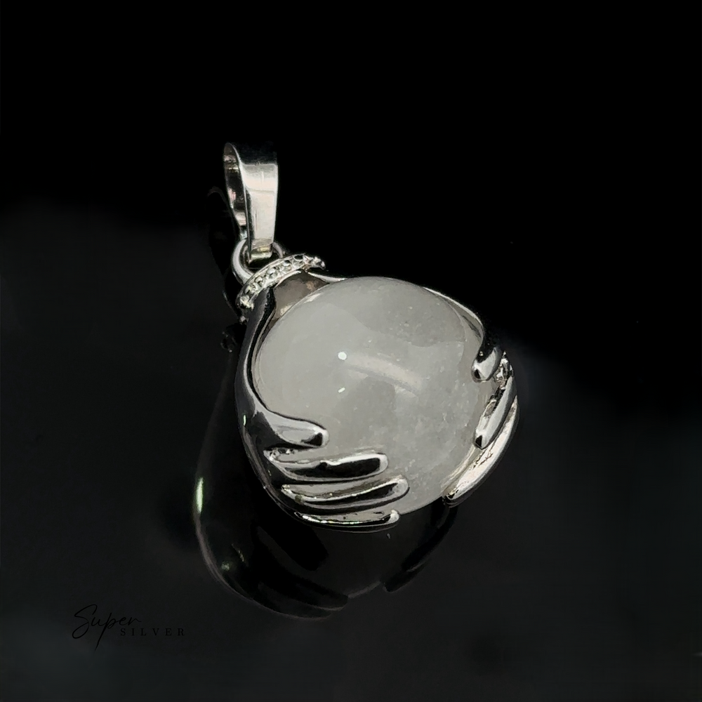 
                  
                    A Sphere Crystal Pendant with a quartz crystal ball held by two sculpted hands, set against a glossy black background. The word "Super Silver" is faintly visible at the bottom left.
                  
                