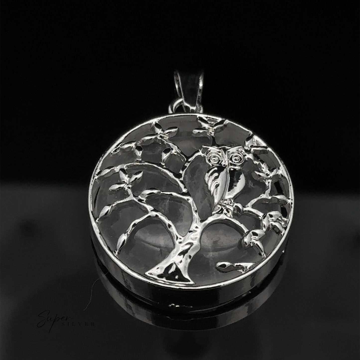 
                  
                    A stunning silver Owl and Tree Pendant featuring an intricate tree design with an owl perched on a branch, set against a black background. The mixed metals add depth and character to this exquisite piece.
                  
                