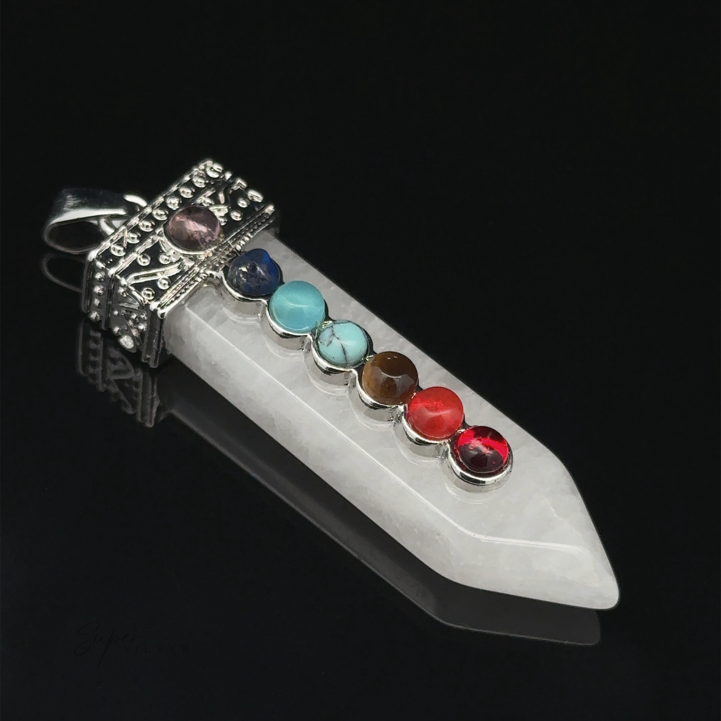 
                  
                    Obelisk Crystal Pendant with Small Chakra Stones featuring a white crystal point adorned with seven chakra stones arranged in a line, hanging from an ornate, silver-plated metal cap with a loop for attaching to a chain.
                  
                