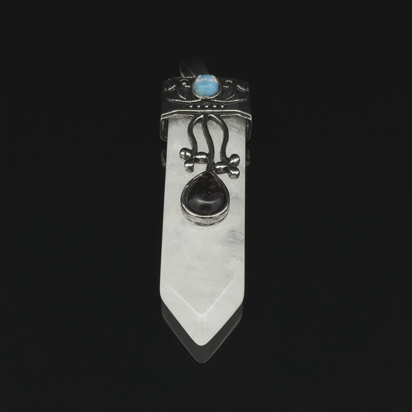 
                  
                    An Obelisk Crystal Stone Pendant with a silver design, featuring a pointed clear quartz and a black gemstone in the center. An opalite gemstone graces the top, all set against a black background.
                  
                