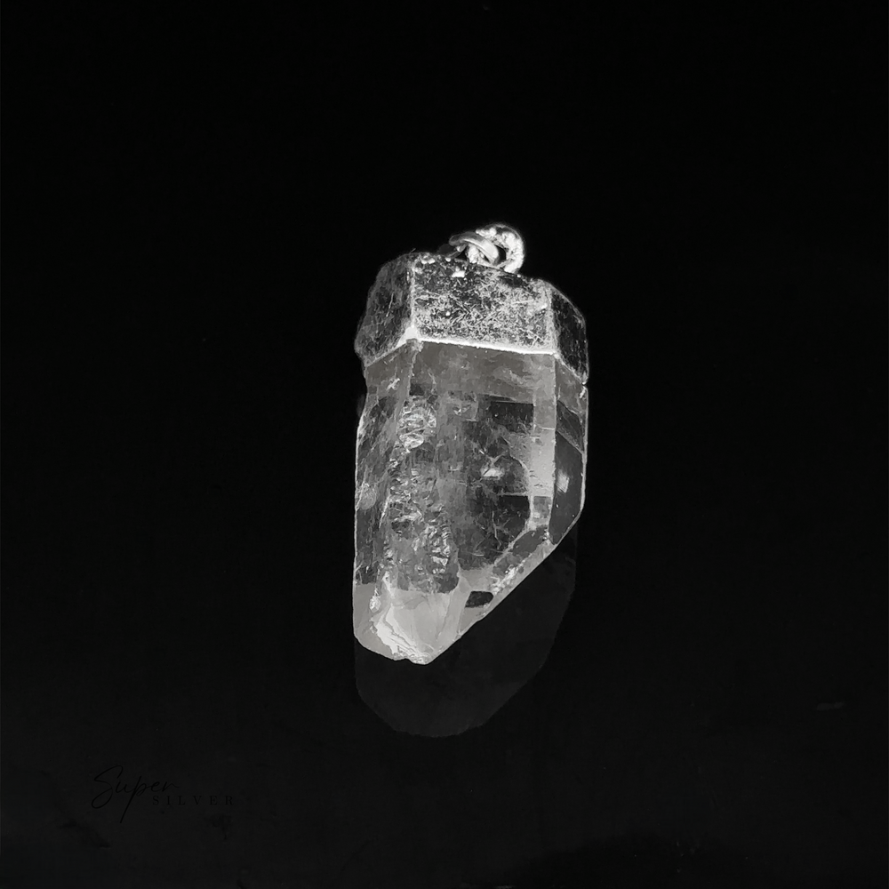 
                  
                    A Raw Crystal Pendant With Silver Cap featuring a transparent quartz crystal with a silver metal cap and bail, photographed against a black background.
                  
                
