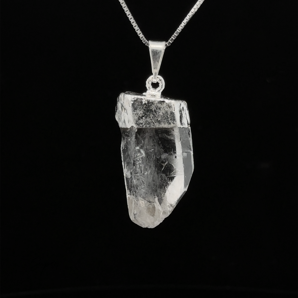 
                  
                    A Raw Crystal Pendant With Silver Cap on a silver chain against a black background. This natural gemstone pendant captures the essence of untouched beauty and mystique.
                  
                