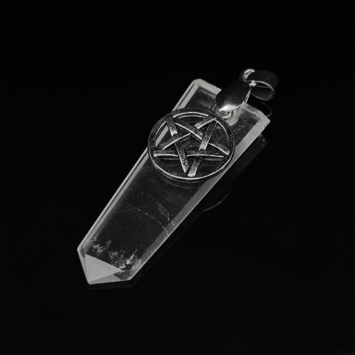 
                  
                    A Pentagram Stone Slab Pendant featuring a clear, faceted crystal point with a hexagram symbol in mixed metals on top, set against a black background.
                  
                