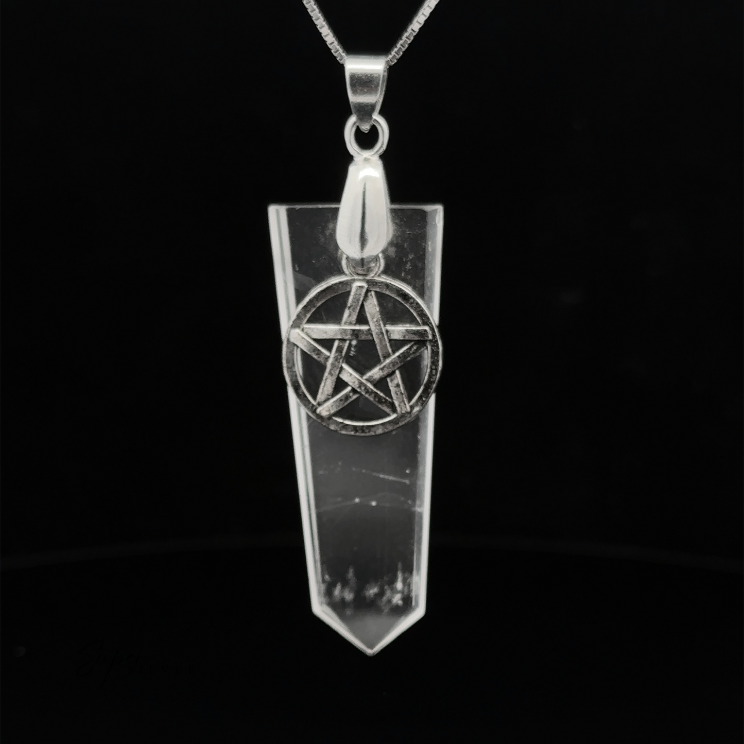 
                  
                    A silver necklace with a Pentagram Stone Slab Pendant hangs elegantly on a black background.
                  
                