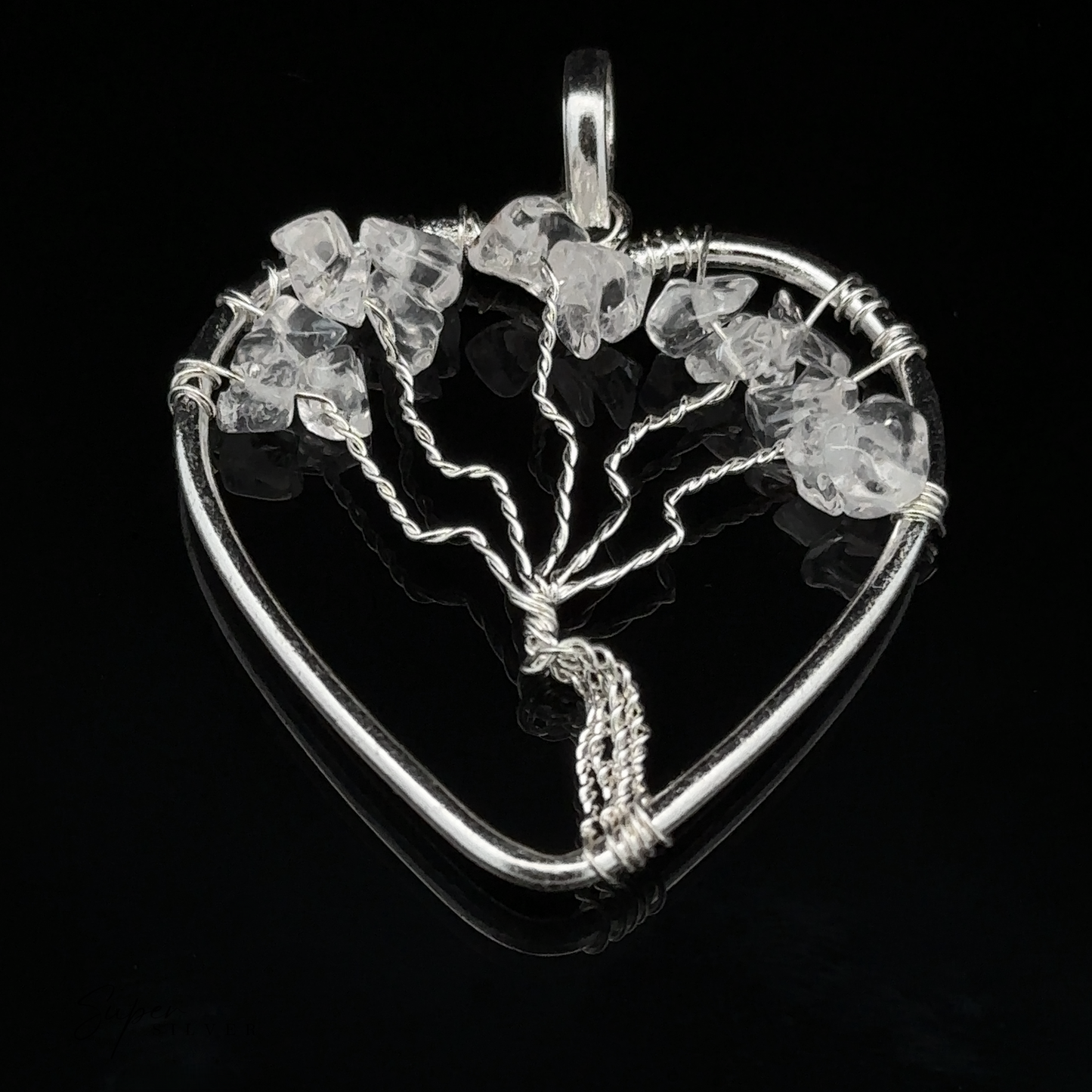 
                  
                    A Heart Shaped Tree of Life Pendant featuring a wire-wrapped design adorned with small clear crystal stones against a black background.
                  
                