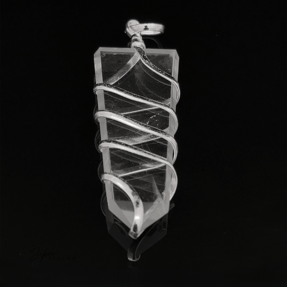 
                  
                    A Wire Wrapped Slab Pendant hanging against a dark background.
                  
                