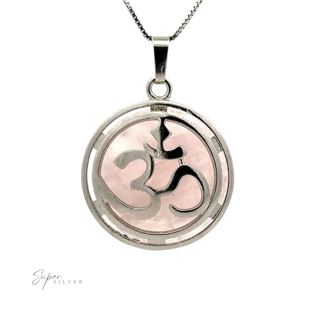
                  
                    An Om Pendant, featuring an enchanting Opalite overlay on a light pink background, displayed on a white backdrop.
                  
                