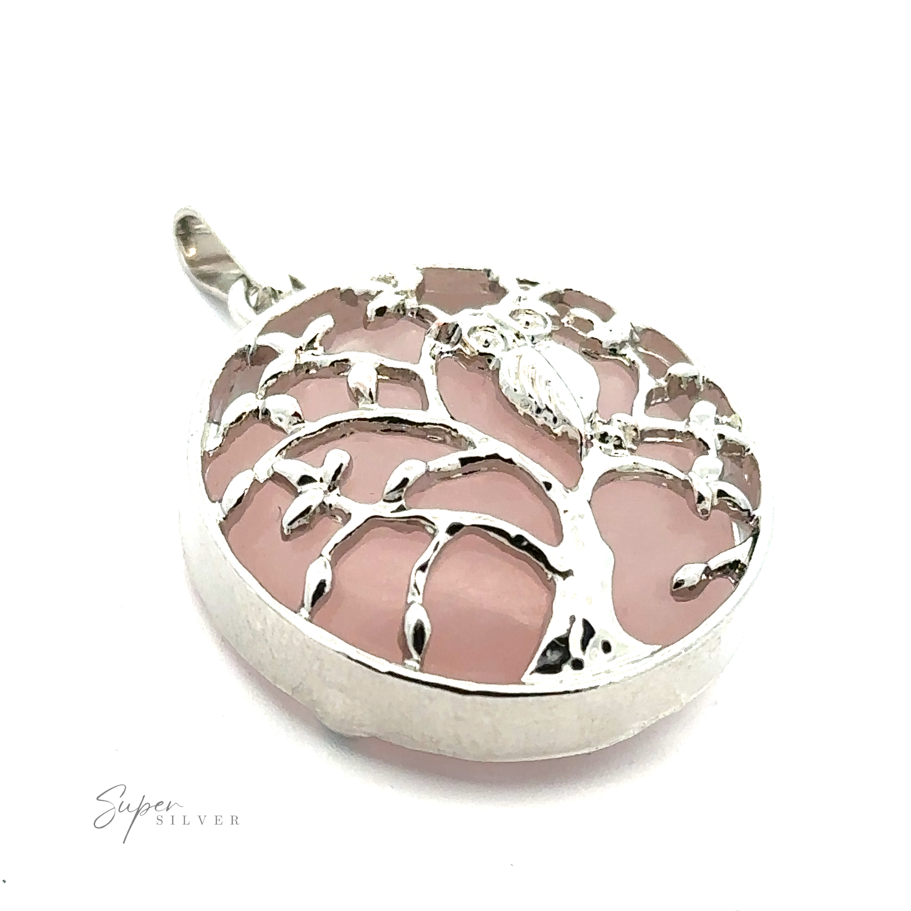 Close-up of a silver pendant with a tree design, featuring a pink background. The pendant, known as the "Owl and Tree Pendant," is embossed with the text "Super Silver" in the bottom left corner.