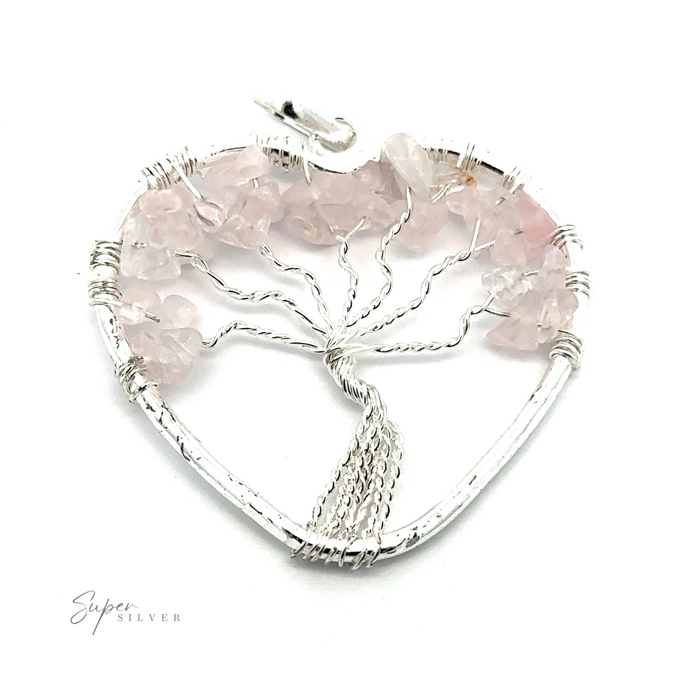 
                  
                    Heart Shaped Tree of Life Pendant with intricate wire detailing forming the Tree of Life, adorned with light pink gemstone chips and raw stone beads.
                  
                