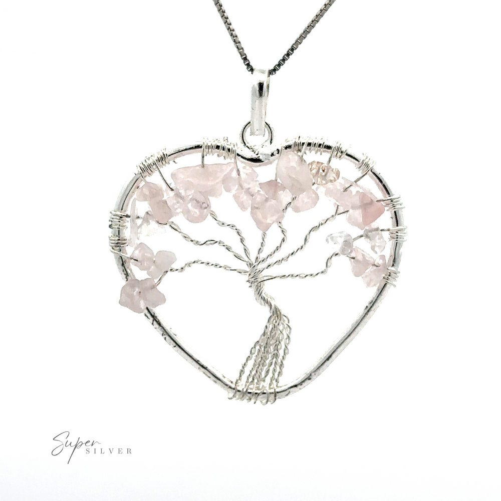 
                  
                    A Heart Shaped Tree of Life Pendant made of silver wire, adorned with pink crystals and complemented by raw stone beads on a silver chain.
                  
                