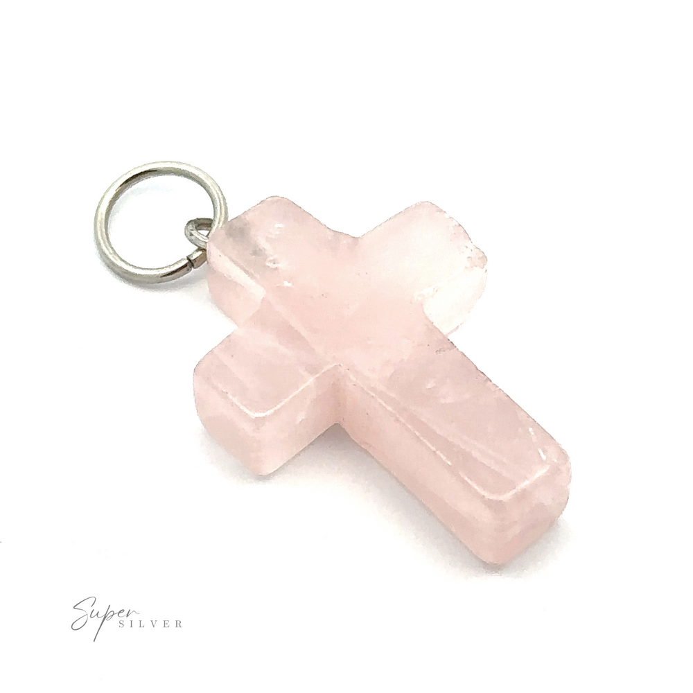 
                  
                    A Stone Cross Pendant featuring a light pink, rose quartz cross with a metal loop for attachment at the top. The stone cross has slightly rough, unpolished edges. The background is plain white.
                  
                