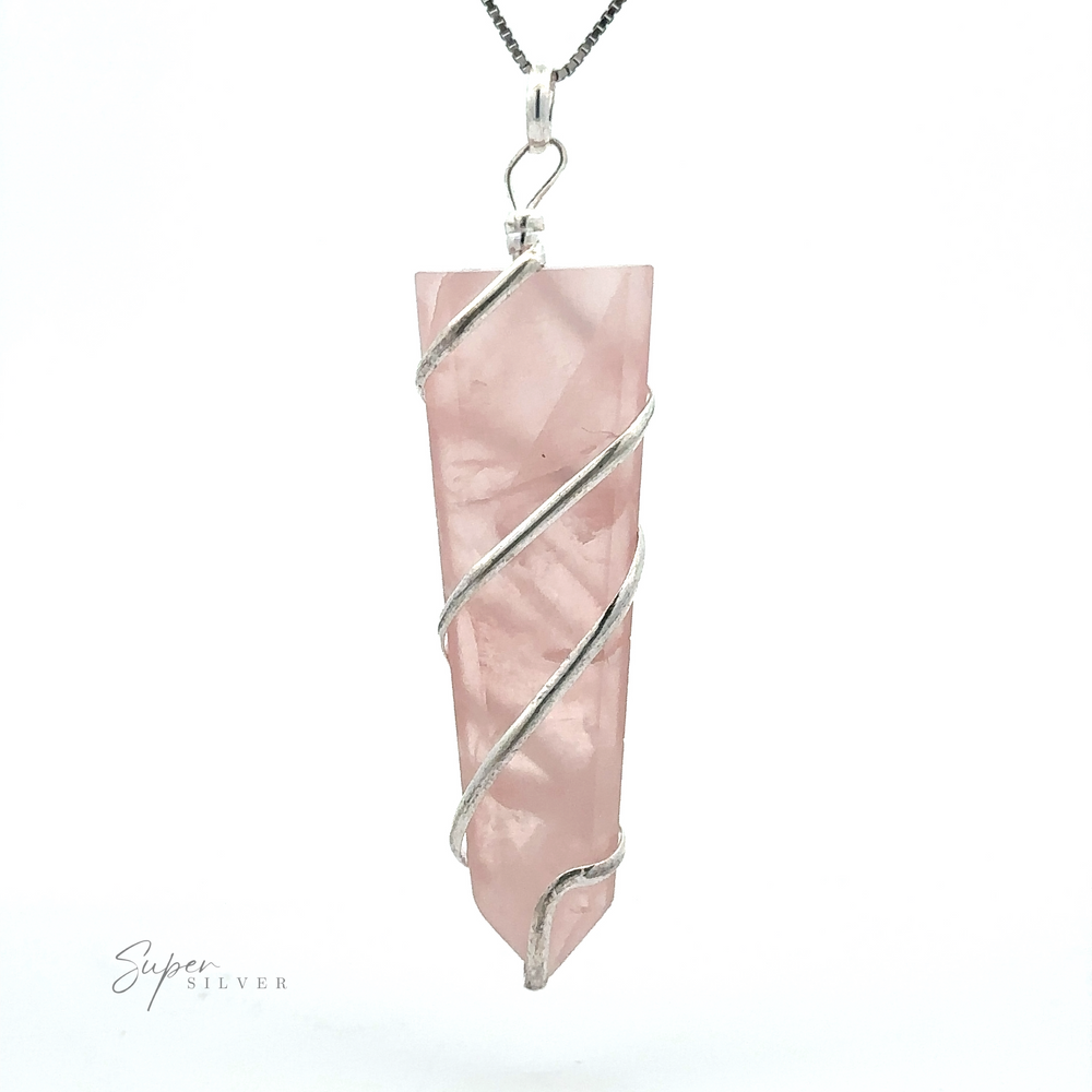 
                  
                    A Wire Wrapped Slab Pendant featuring a rose quartz crystal encased in a silver design, hanging from a thin chain, exemplifying exquisite gemstone jewelry craftsmanship.
                  
                