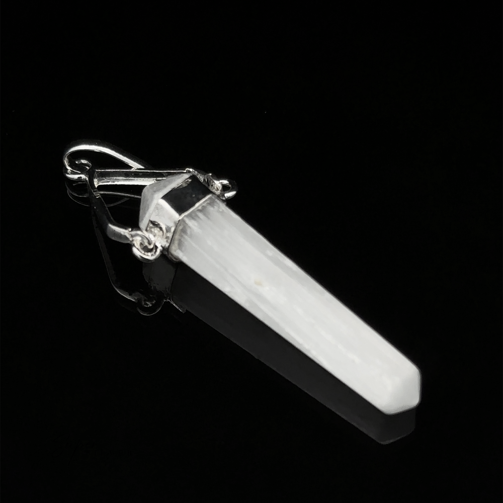 
                  
                    A Raw Stone Swivel Pendant, set in a silver-plated setting, on a black background.
                  
                
