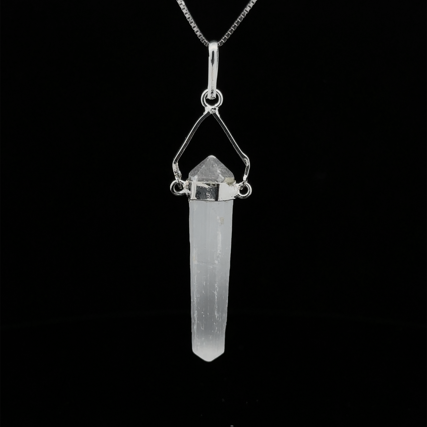 
                  
                    A Raw Stone Swivel Pendant featuring a clear crystal wrapped in a silver-plated setting, hanging from a silver chain, all set against a black background.
                  
                