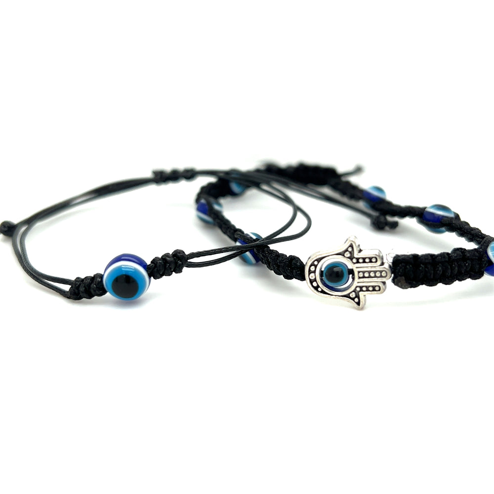 A pair of adjustable Super Silver evil-eye bracelets with a boho vibe, featuring black beads.