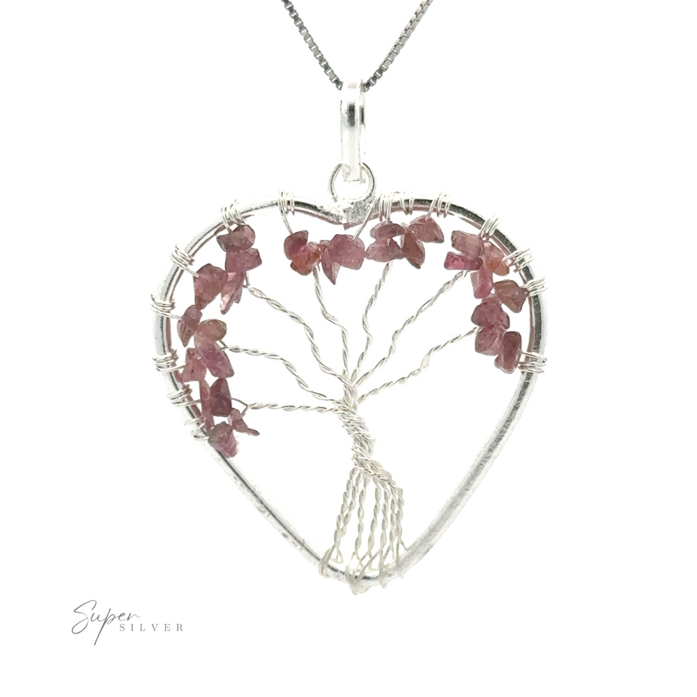 
                  
                    Heart Shaped Tree of Life Pendant featuring a wire tree design with pink gemstone leaves, hanging from a delicate chain adorned with raw stone beads.
                  
                