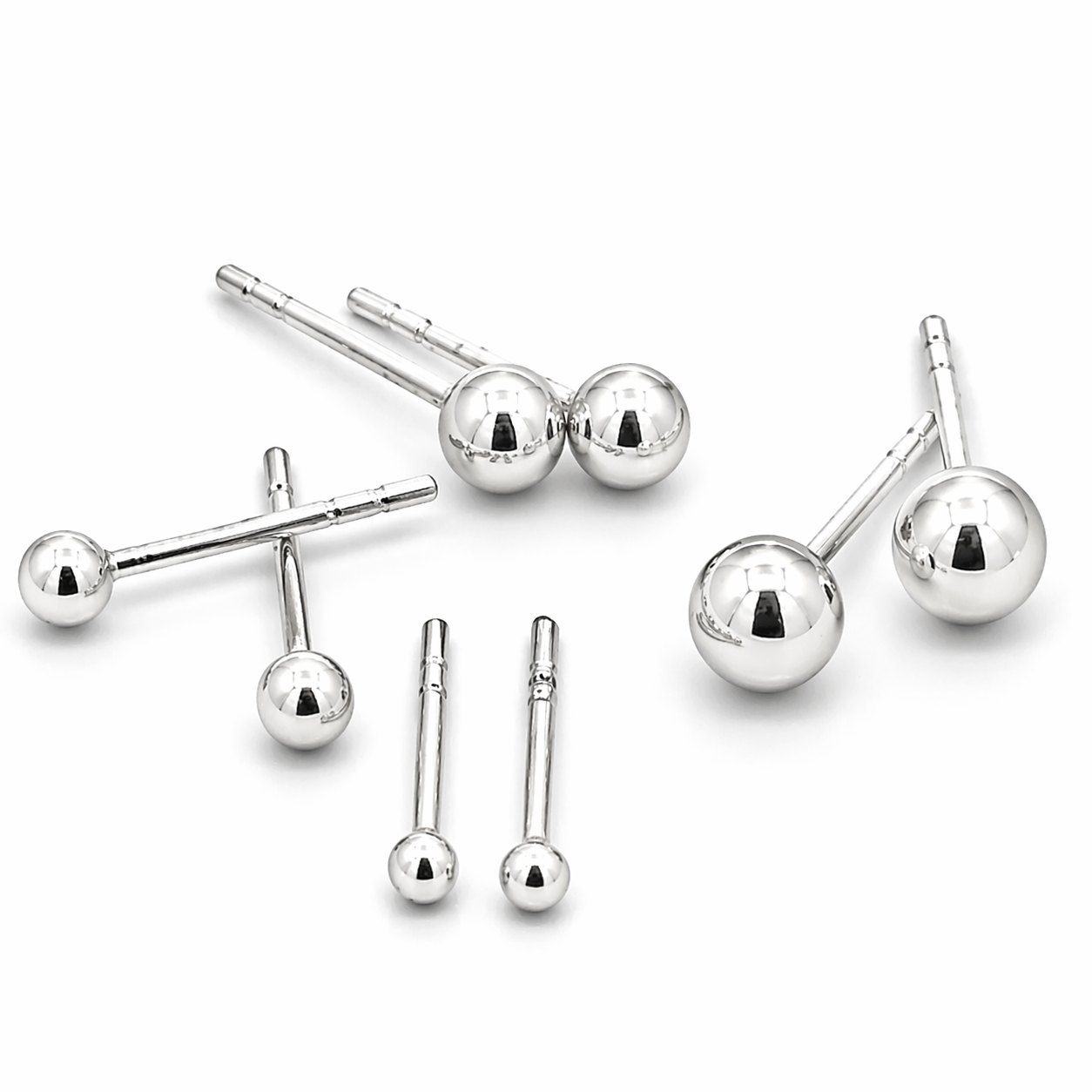 The Simple Silver Ball Studs set features six pairs of classic sterling silver ball stud earrings in assorted sizes, displayed on a white background—perfect as an everyday jewelry essential.